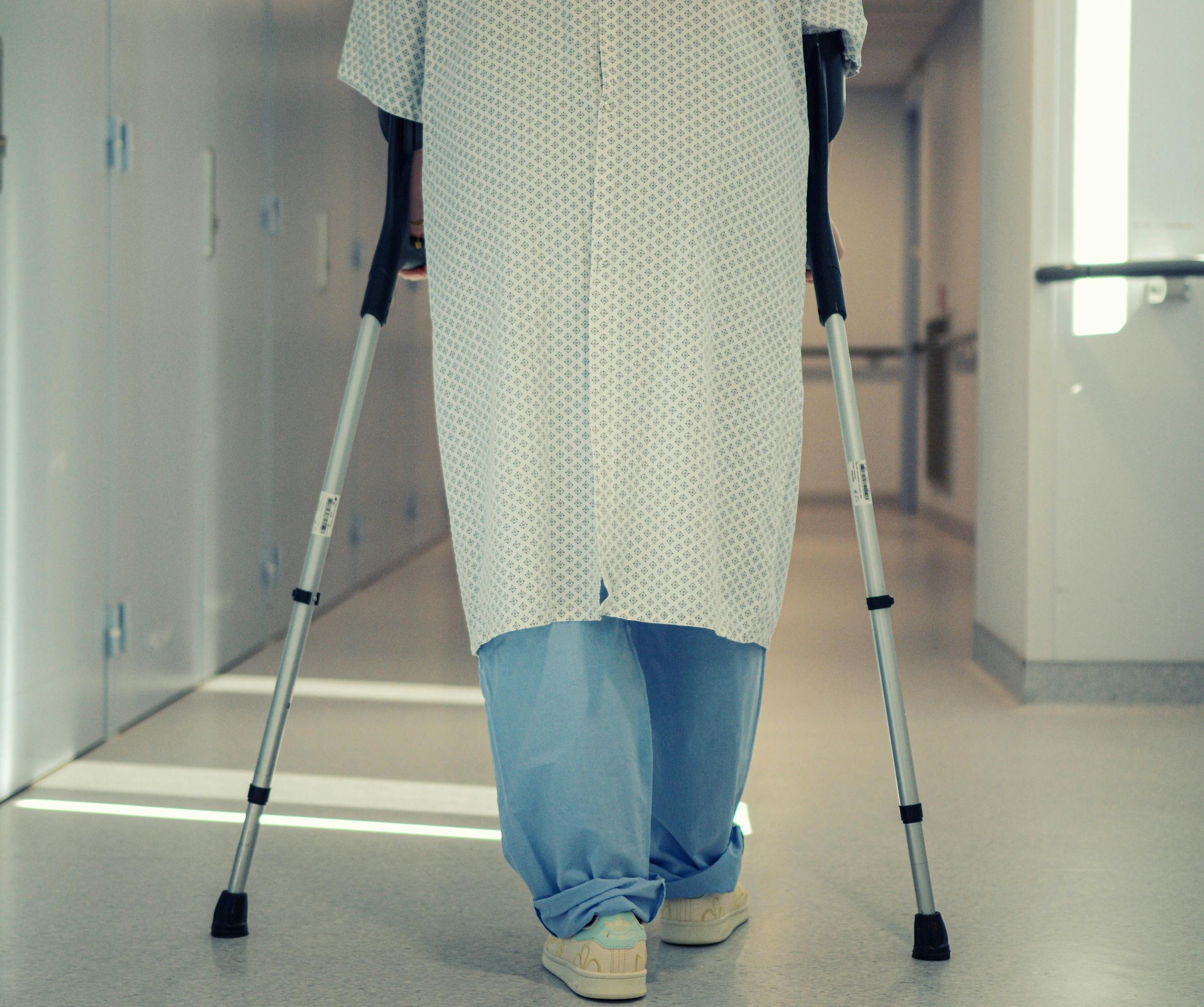 Post-surgery patient walking with crutches due to defective depuy asr hip recall lawsuit complications
