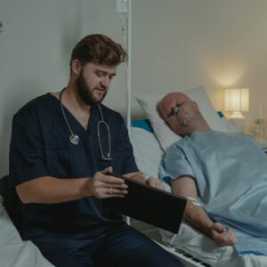 Doctor consulting over chart beside patient in hospital bed during fentanyl pain patch lawsuit overdose treatment