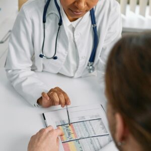 Doctor reviewing medical chart with patient during Ozempic vision loss lawsuit consultation