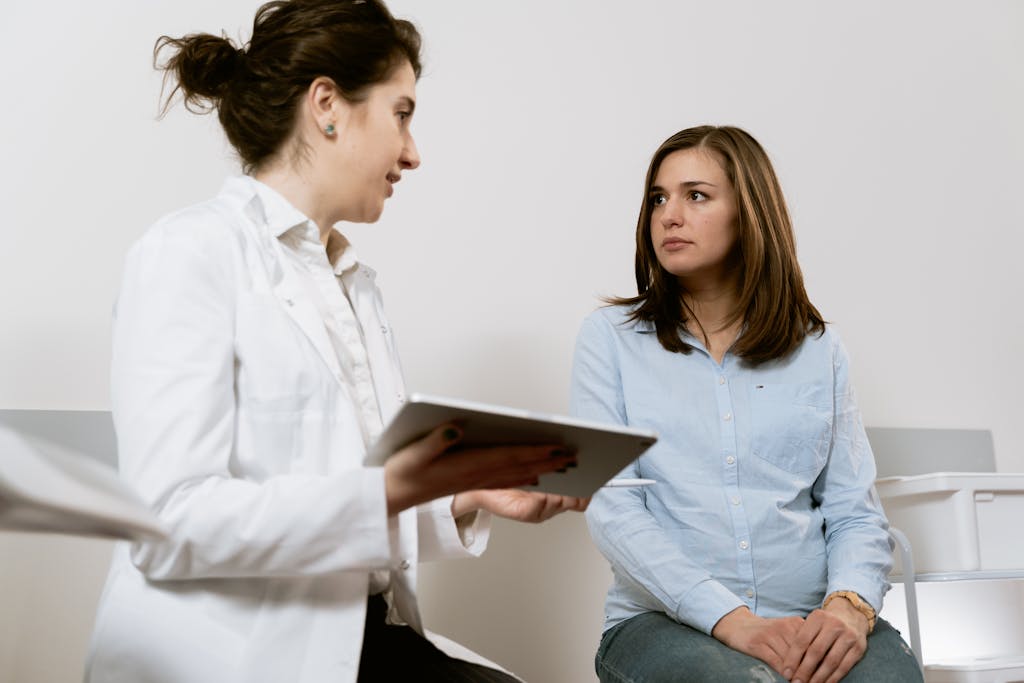 Female patient consulting with doctor about complications related to transvaginal mesh implant