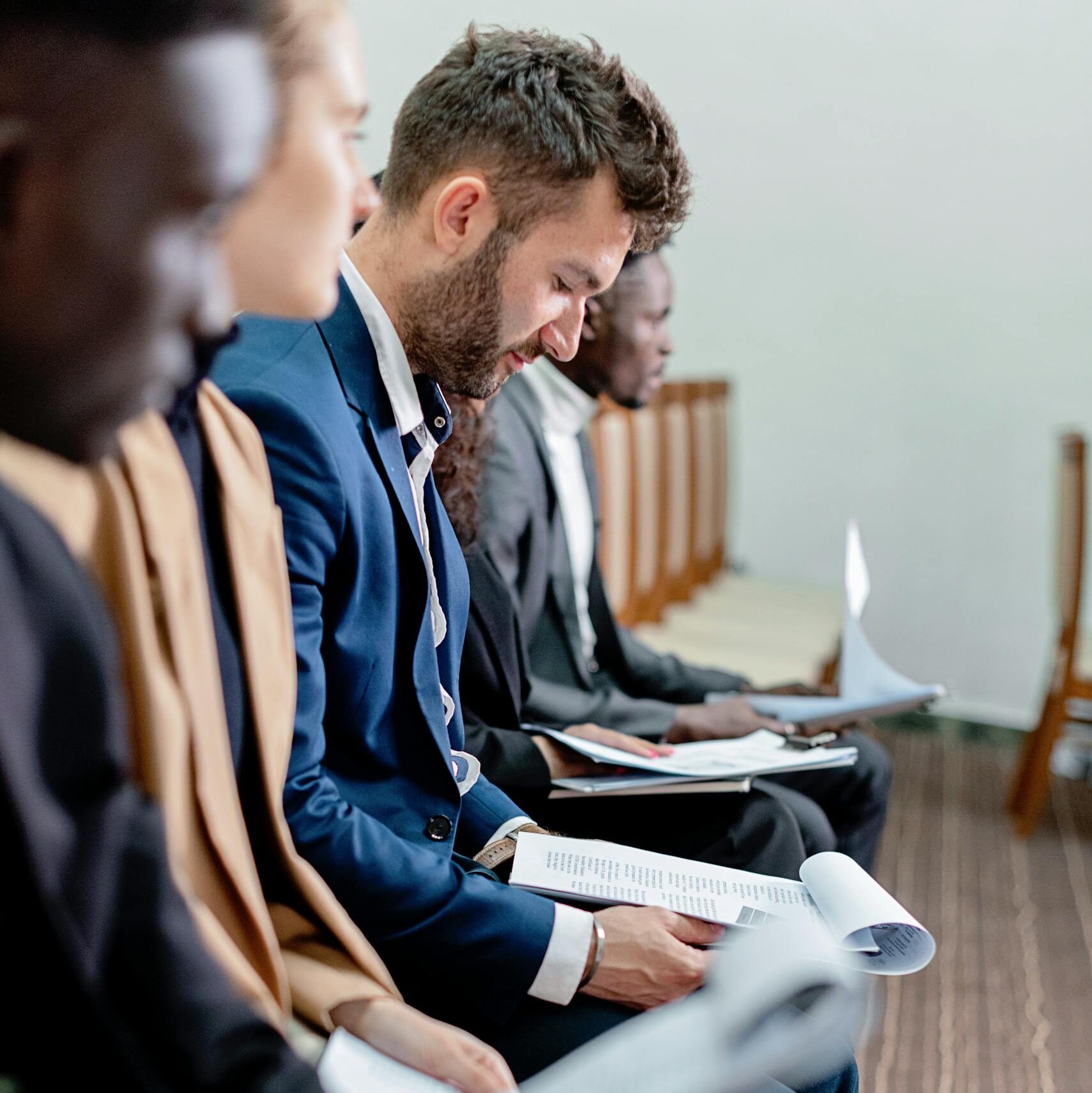 Prospective clients reviewing case documents in a waiting room