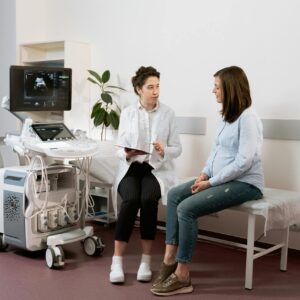 Pregnant woman discussing ultrasound results with doctor during Depo-Provera lawsuit evaluation