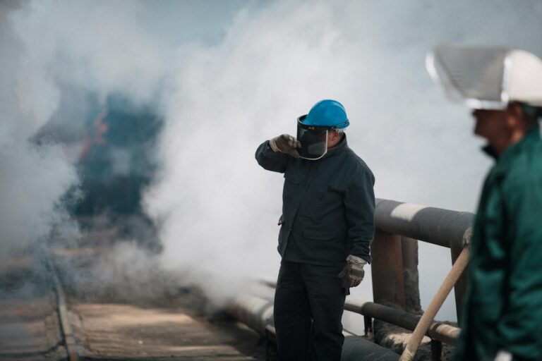 Workers exposed to asbestos dust and smoke, highlighting mesothelioma risks