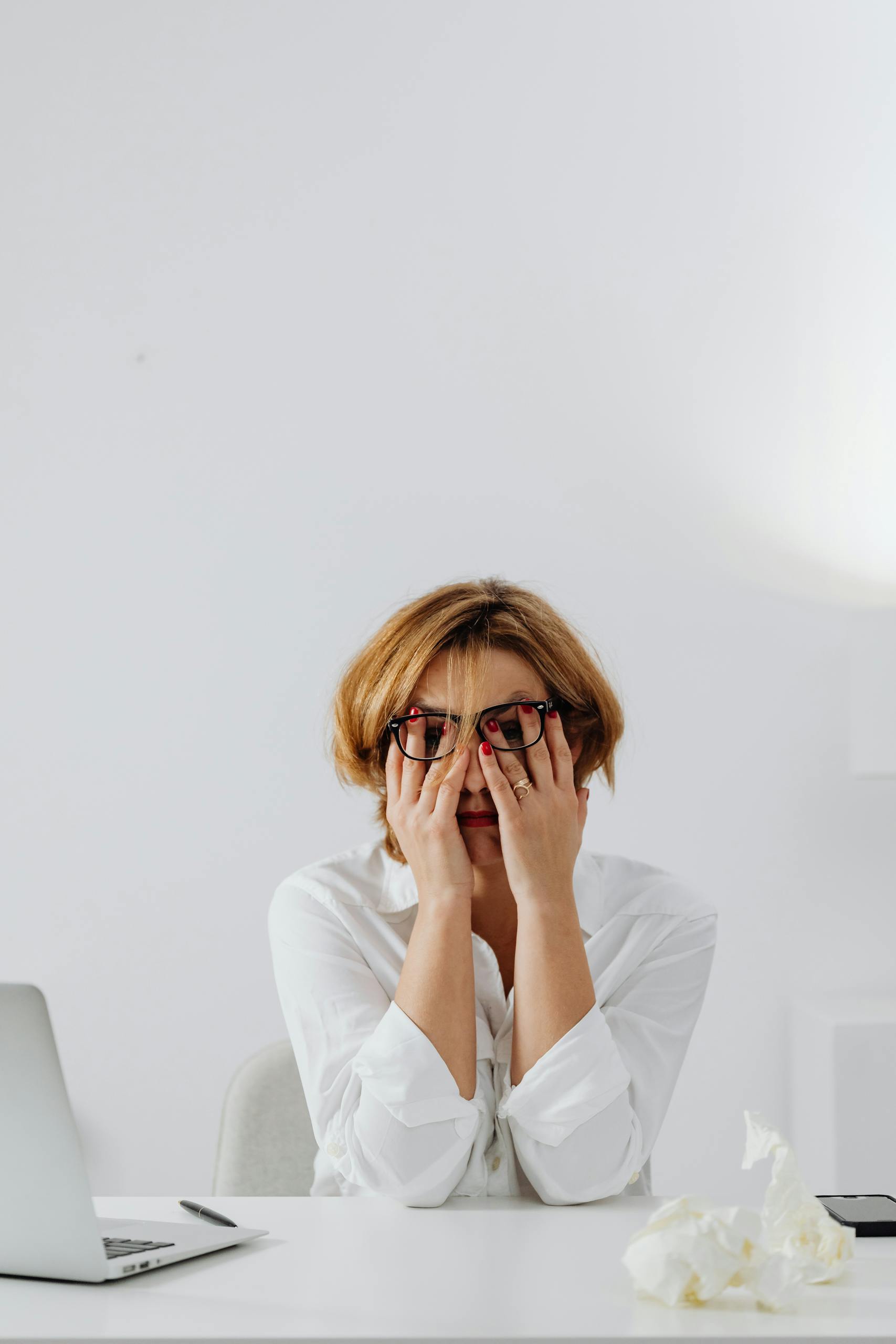 Stressed client at desk with hands on face, illustrating warning signs of a Texas legal malpractice case