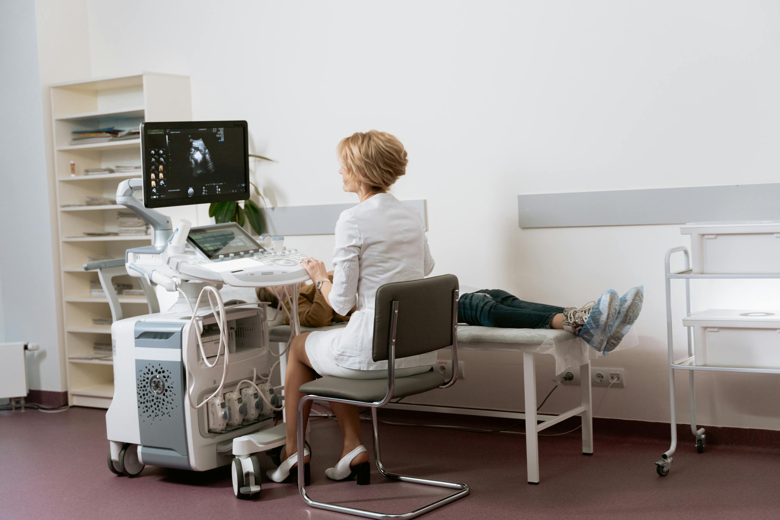 Female doctor performing pelvic ultrasound to evaluate complications from transvaginal mesh lawsuit