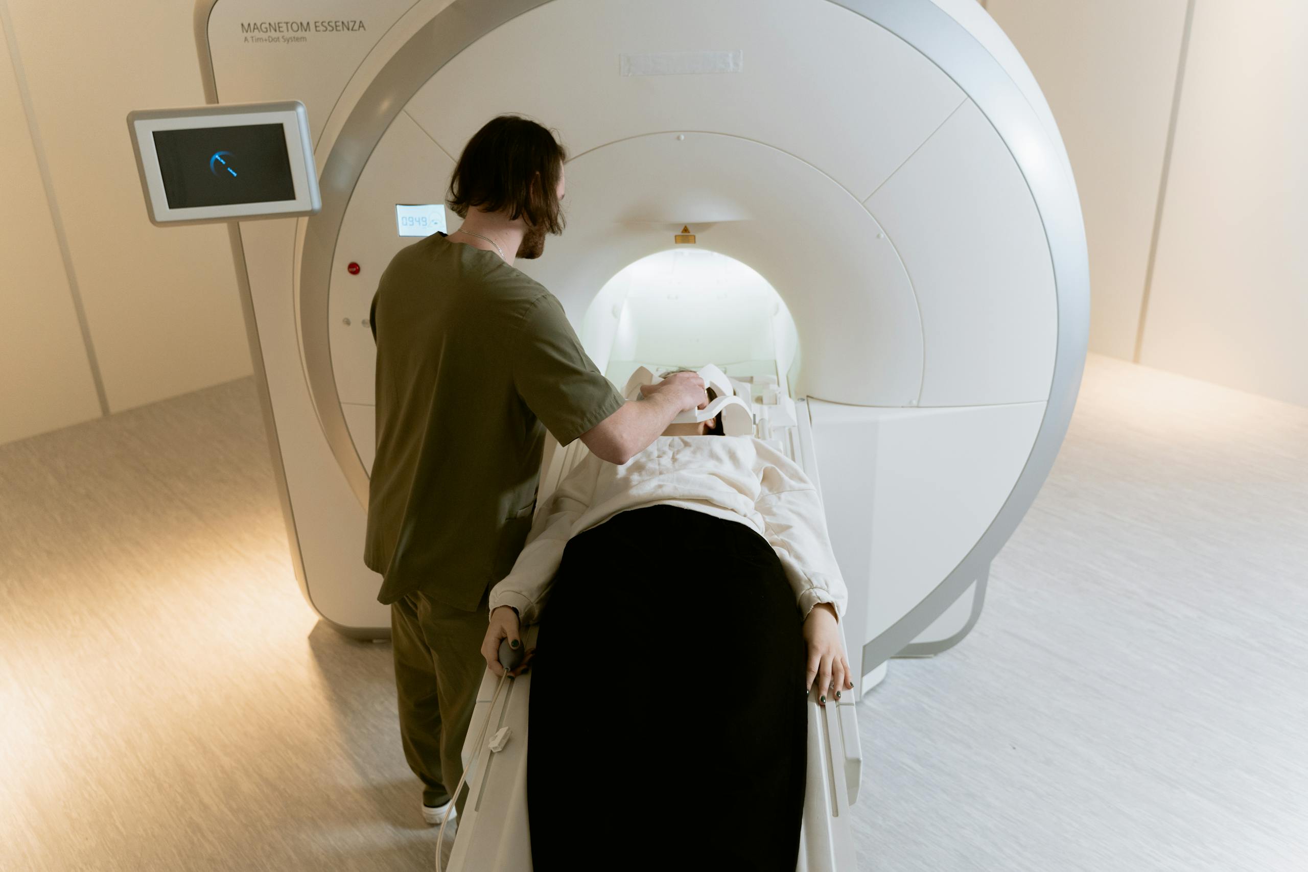 Patient undergoing MRI scan with gadolinium-based contrast agent under technician supervision - Gadolinium MRI Lawsuit