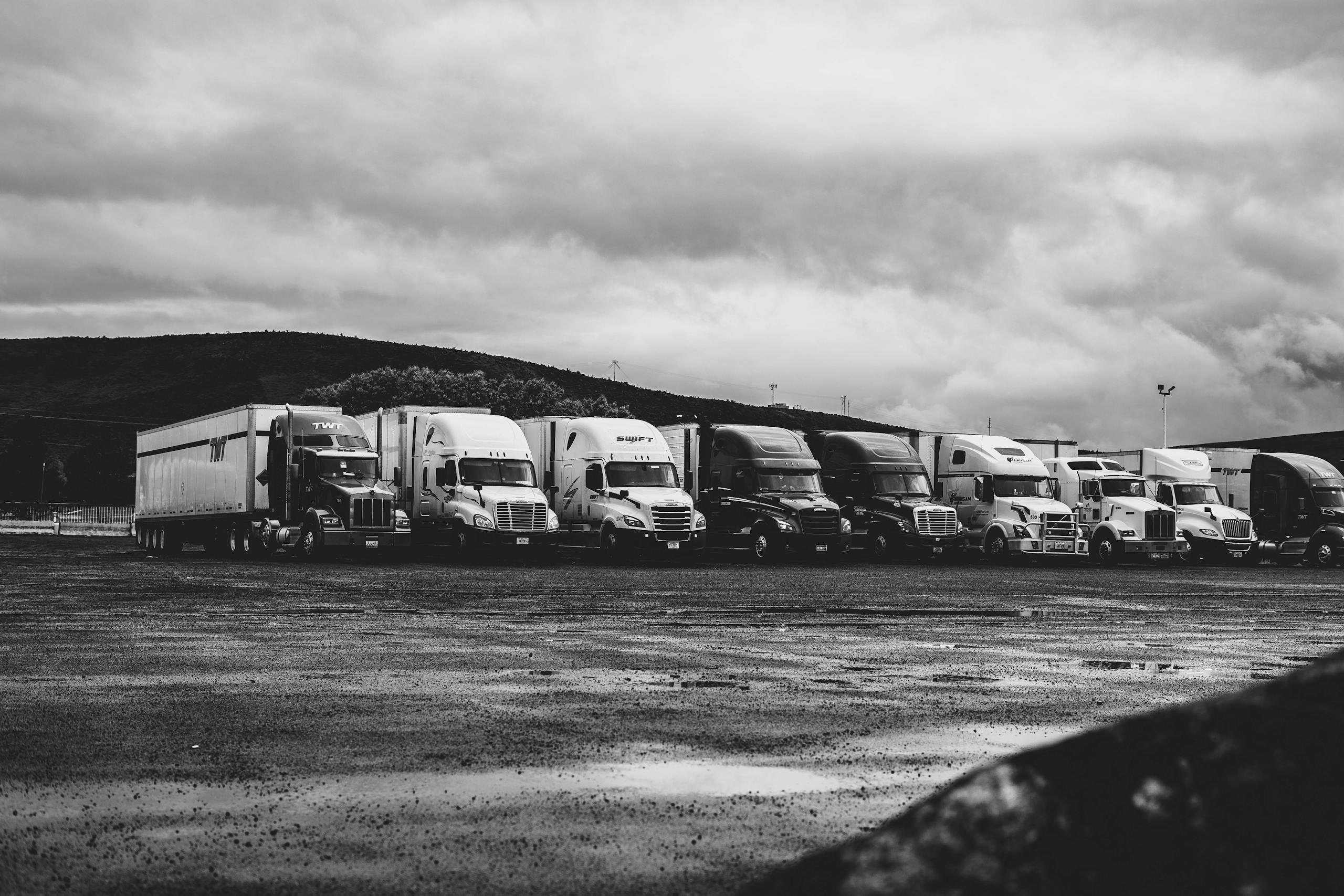 Row of commercial semi-trucks in lot - handling Texas Truck Accident and 18-Wheeler cases
